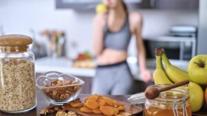 Young woman is eating an apple after a workout.